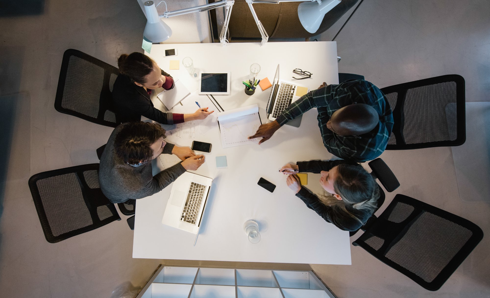 Strategy meeting around a white table